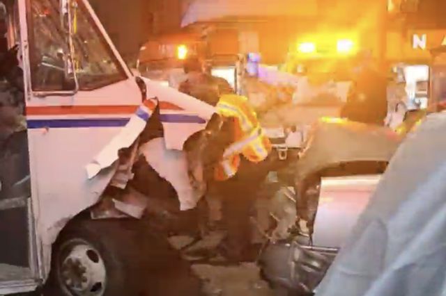 A damaged postal truck that crashed into a parked car is being assessed by a mechanic after the truck deliberately plowed into several parked cars in Brooklyn on Friday.